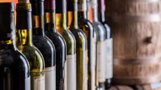 bigstock Wine bottles in row and oak wi 266354959